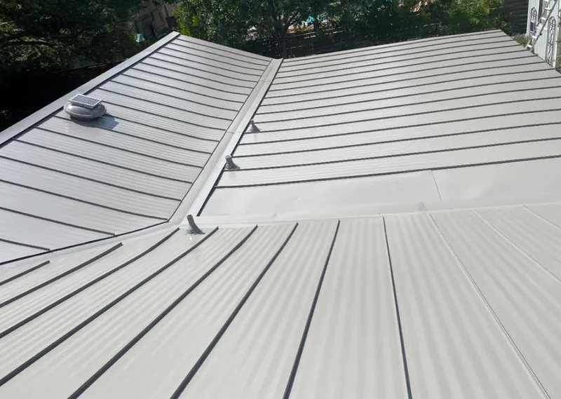 Solar attic fan installed on a metal roof for Roof Ventilation in Raton